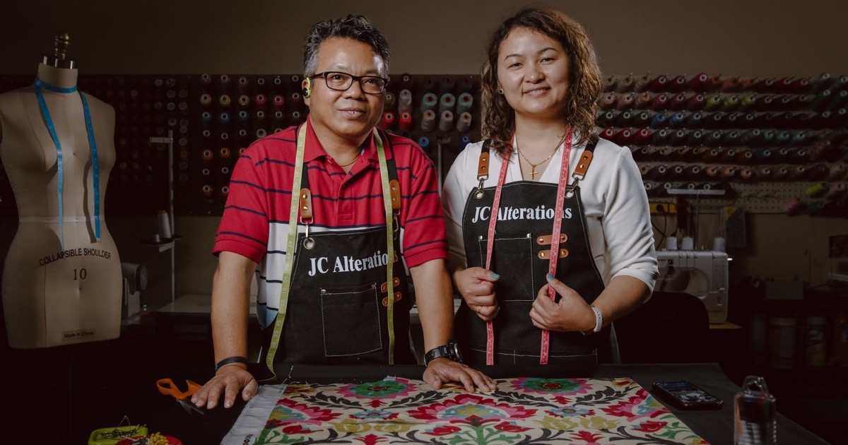 JC Alterations owners in their tailoring shop